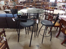 Glass topped iron legged bar-high table.  Comes with 4 black matching bar stools.  2 are captain, 2 are open seating.  
$168.80