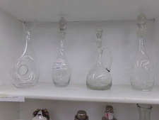 FANCY GLASS DECANTERS.  Has the stopper - for fancy service.  Find in kitchen with other glassware.
Featured decanter comes with 5 glasses and a bell.
$16.90
