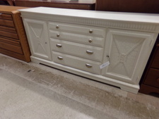 The finish on this dresser looks like white marble.  The top drawer is a double.  then has 2 lower drawers and the cupboards at both ends.  
$335.50