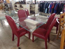 This 6 ft dining table has clear glass top, white stone-look pedestals and is surrounded by 6 red leather chairs.  (not sure of leather authenticity)  2 chairs are armed. others open
$715.20