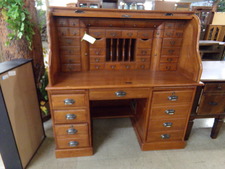 OAK ROLL TOP DESK.  This desk top has more little drawers and file options than most.  Base has computer tower and other organizing drawers.  
Enter the store, walk straight then go to the right 
$995.00