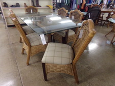 WICKER & RATTAN Glass top dining table.  Come with 6 chairs skirted with woven wicker.  pedestal is a table shaped rattan and wicker blend rectangle shape.
$995.00