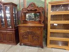 BEAUTIFUL GOLD OAK BUFFET CABINET.  Has mirrored top and lantern shelves.  Very ornate wood carving makes this a real eye-catcher
$2995.00