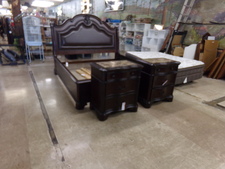 DARK WOOD KING BED.  This bedframe is complete with a leather front panel.  Comes with 2 matching side tables that have marble tops.   Sold as set.  No mattress No
$1595.00