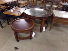ROUND RED-WOOD LOOK TABLES.  The larger one is approx 30