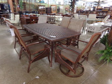 PATIO SET.  Looks like copper!  Large metal table comes with 6 chairs - two are swivel rockers - 4 are stationary.  Very nice.
$550.00