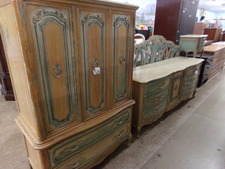 LARGE BEDROOM ENSEMBLE.  A refurbished bedroom set antiqued with green accenting.  The wardrobe top has 3 drawers hidden behind the doors, also get long dresser, King headboard, 2 mirrors and 2 side tables.  
$825.00
